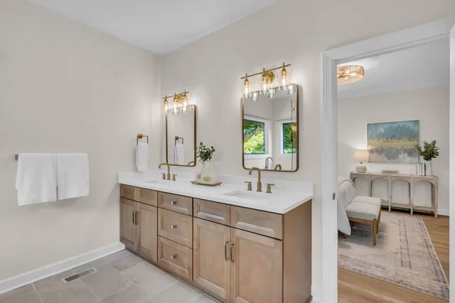a spacious bathroom with a double vanity sink and a mirror