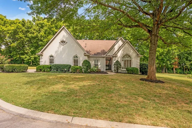 a view of a house with pool and a yard