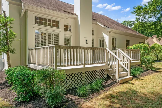 a view of a house with a small yard and wooden fence