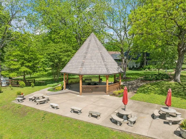 a backyard of a house with table and chairs