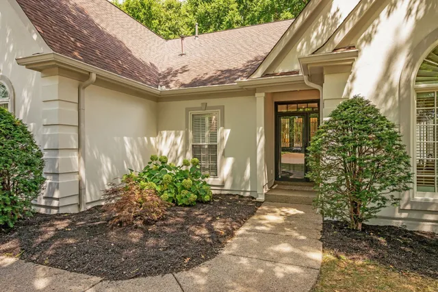 a view of a patio with table and chairs and potted plants