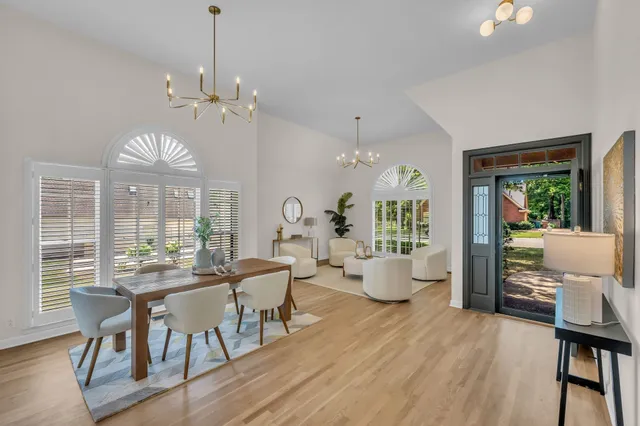 a view of a dining room with furniture wooden floor and chandelier
