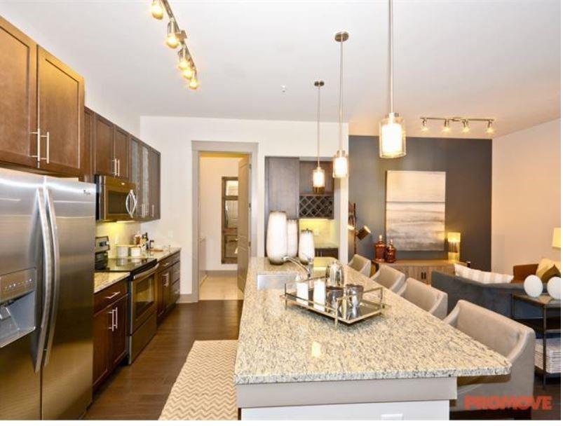 4600 Roswell Road, Unit 459 Sandy Springs, GA 30342 - Photo 2 of 7 a kitchen with granite countertop kitchen island stainless steel appliances a sink counter space and living room view