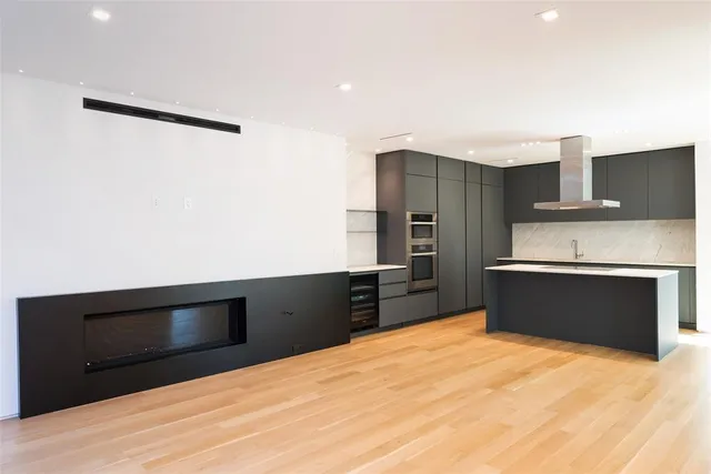 a kitchen with granite countertop a refrigerator and a stove top oven