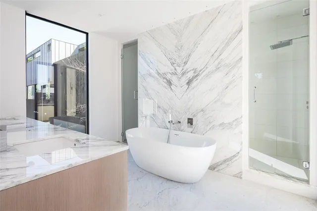 a spacious bathroom with a bathtub and shower