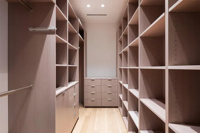 a view of walk in closet with empty racks