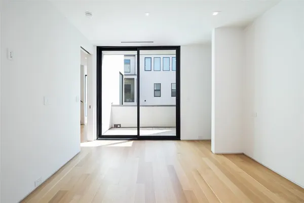 a view of a room with wooden floor