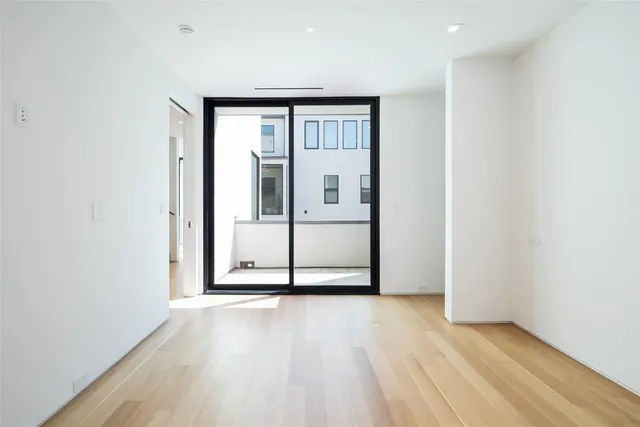 a view of a room with wooden floor