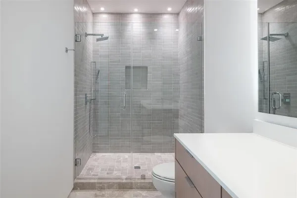 a bathroom with a sink a toilet and shower