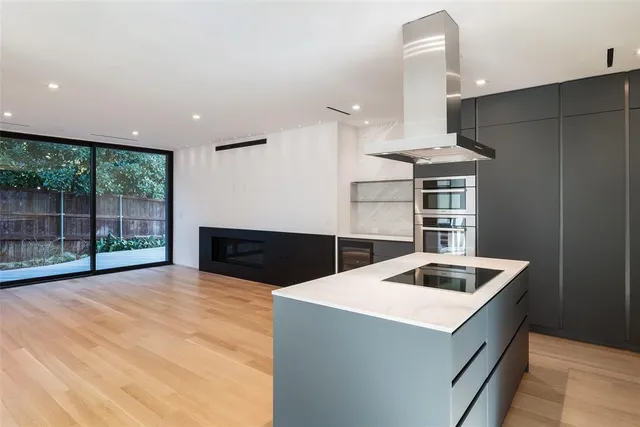 a kitchen that has a sink and a stove top oven