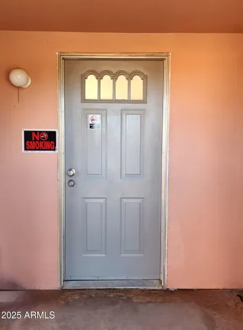a view of a room with wooden floor and window
