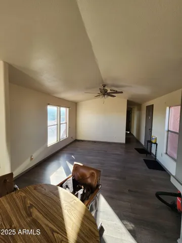 a kitchen with stainless steel appliances granite countertop a refrigerator a stove a sink a table and chairs