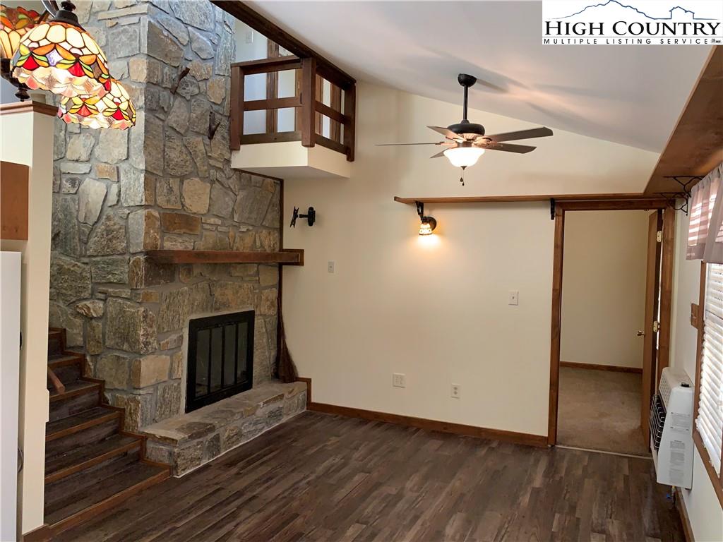 117 Horseshoe Ridge Road East Deep Gap, NC 28618 - Photo 17 of 50 a view of a hallway with wooden floor and a fireplace