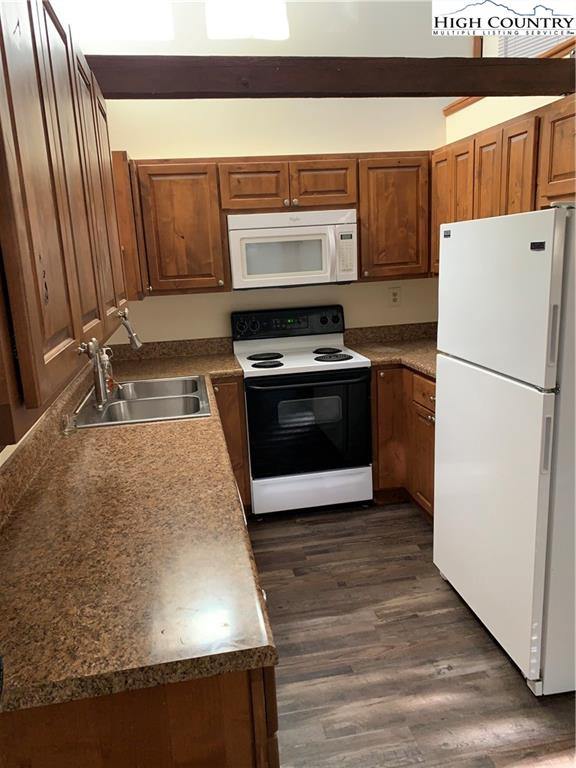117 Horseshoe Ridge Road East Deep Gap, NC 28618 - Photo 28 of 50 a kitchen with wooden cabinets and a stove top oven