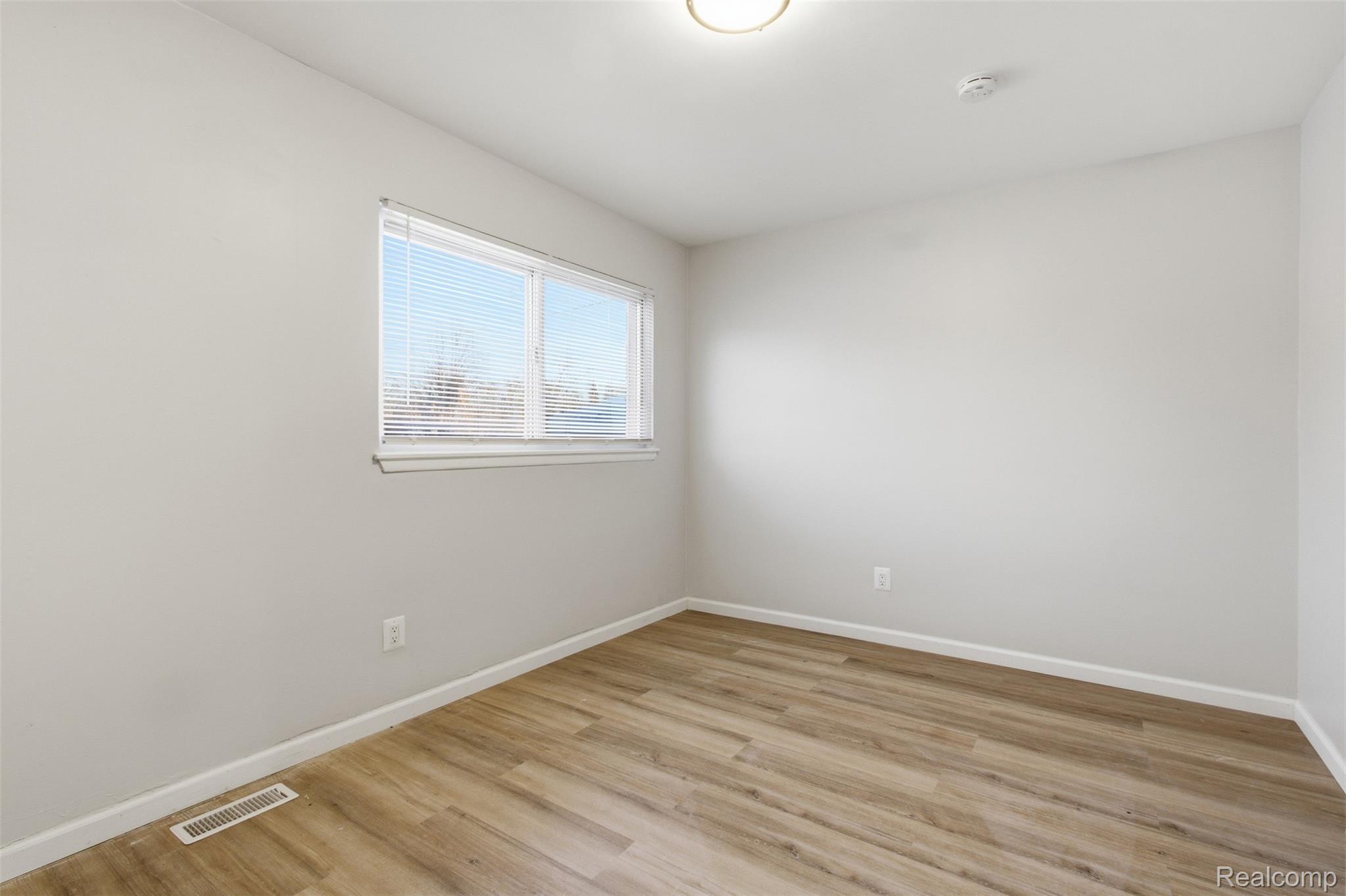 14731 Stephens Road Eastpointe, MI 48021 - Photo 12 of 15 Unfurnished room featuring light wood-type flooring and baseboards