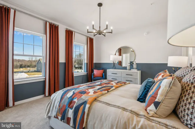 a bedroom with a bed ceiling fan and a window