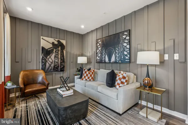 a living room with furniture and a lamp