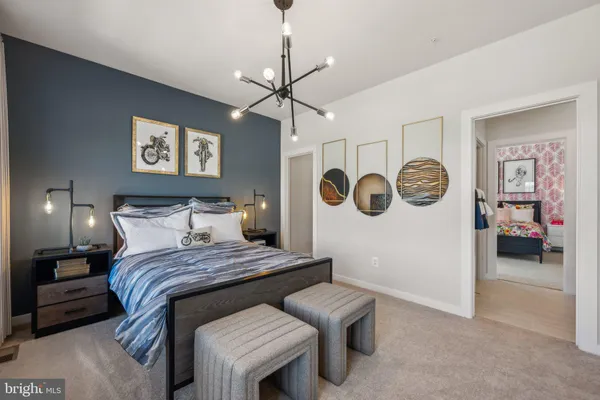 a bedroom with a bed and a chandelier