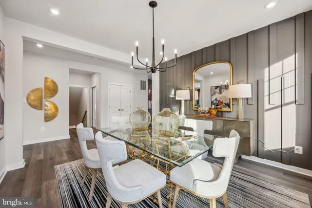 a view of a dining room with furniture wooden floor and chandelier
