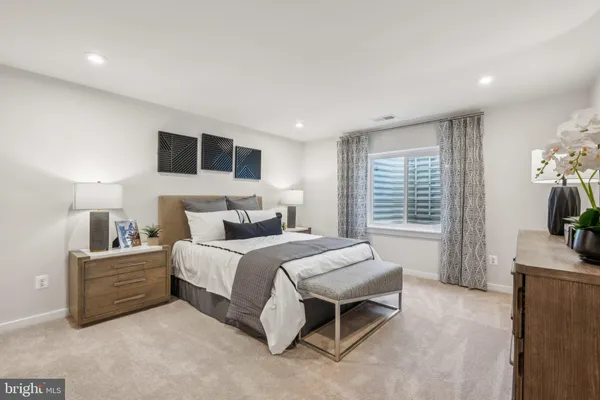a spacious bedroom with a bed and a flat screen tv