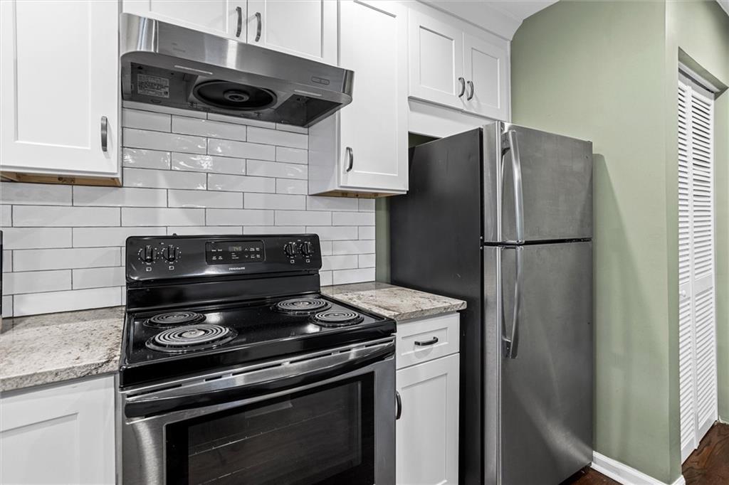 144 Woodmere Square Northwest Atlanta, GA 30327 - Photo 11 of 39 a kitchen with stainless steel appliances a refrigerator a stove and a sink