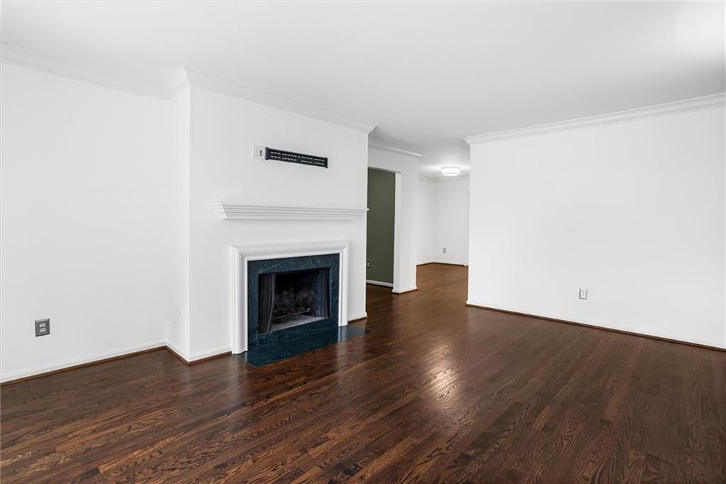 144 Woodmere Square Northwest Atlanta, GA 30327 - Photo 20 of 39 a view of an empty room with wooden floor and a fireplace