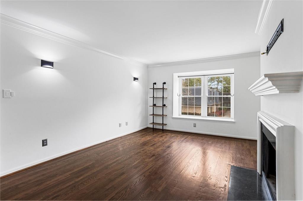144 Woodmere Square Northwest Atlanta, GA 30327 - Photo 21 of 39 an empty room with wooden floor and a window