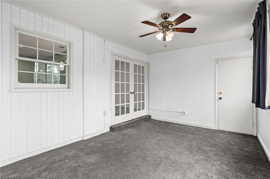 144 Woodmere Square Northwest Atlanta, GA 30327 - Photo 23 of 39 an empty room with ceiling fan and windows