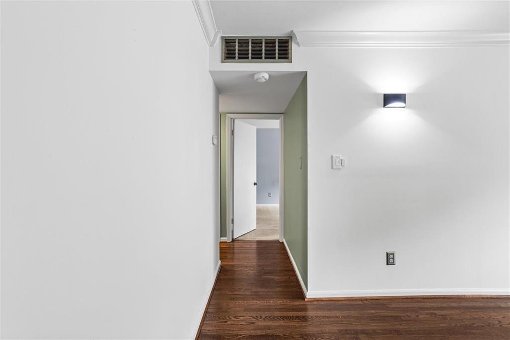 144 Woodmere Square Northwest Atlanta, GA 30327 - Photo 25 of 39 a view of a hallway with wooden floor and a bathroom