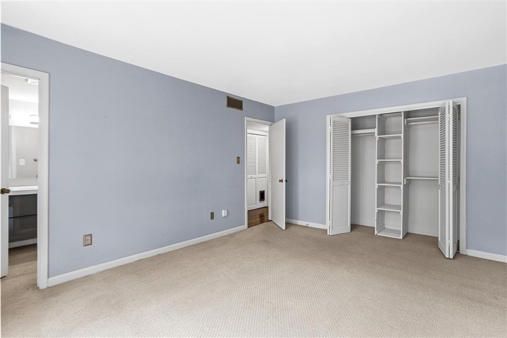 144 Woodmere Square Northwest Atlanta, GA 30327 - Photo 28 of 39 an empty room with closet area
