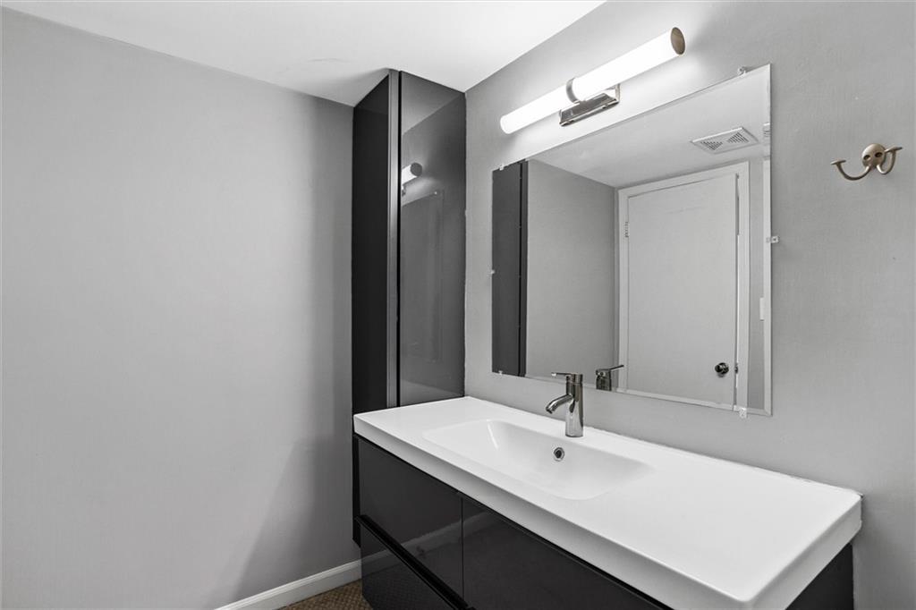 144 Woodmere Square Northwest Atlanta, GA 30327 - Photo 29 of 39 a white bathroom with sink and mirror