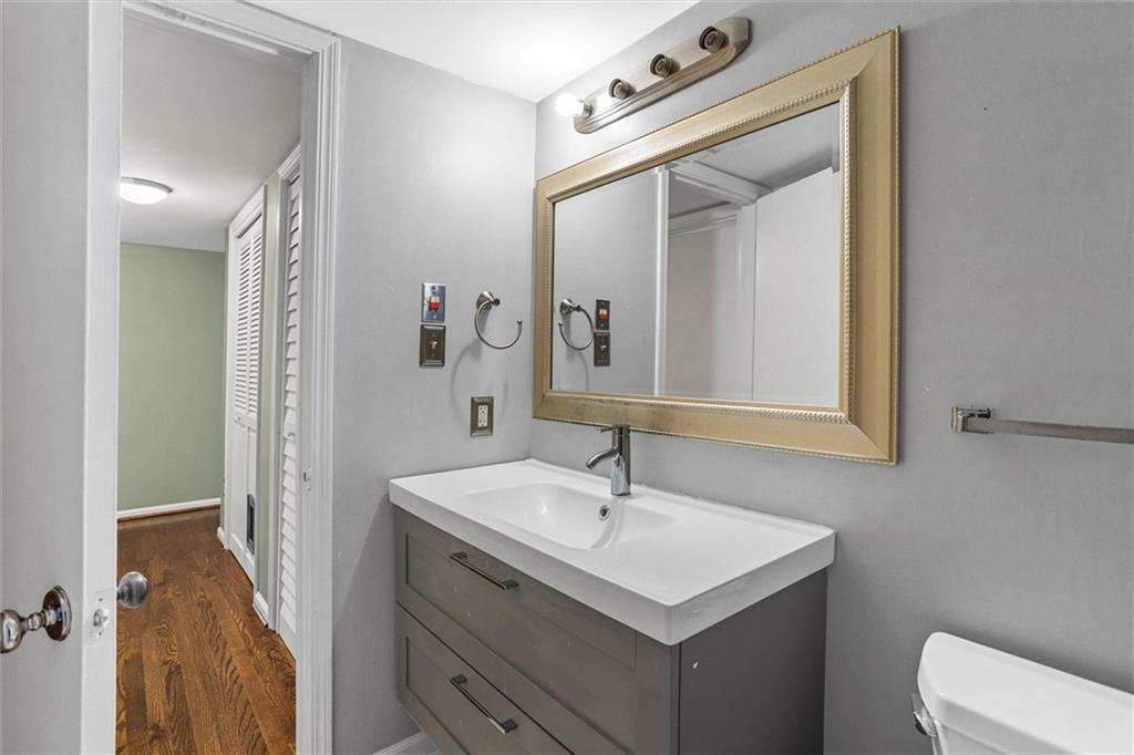 144 Woodmere Square Northwest Atlanta, GA 30327 - Photo 33 of 39 a bathroom with a sink vanity and mirror