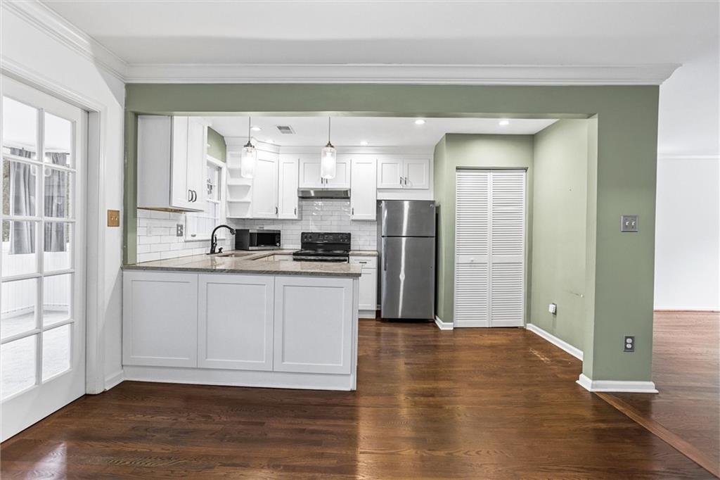 144 Woodmere Square Northwest Atlanta, GA 30327 - Photo 8 of 39 a kitchen with stainless steel appliances a refrigerator and a hard wood floor