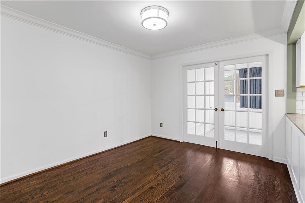 144 Woodmere Square Northwest Atlanta, GA 30327 - Photo 10 of 39 an empty room with wooden floor and windows