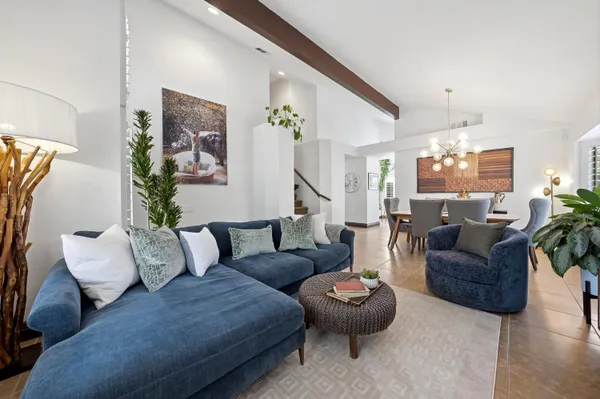 a living room with furniture and a chandelier