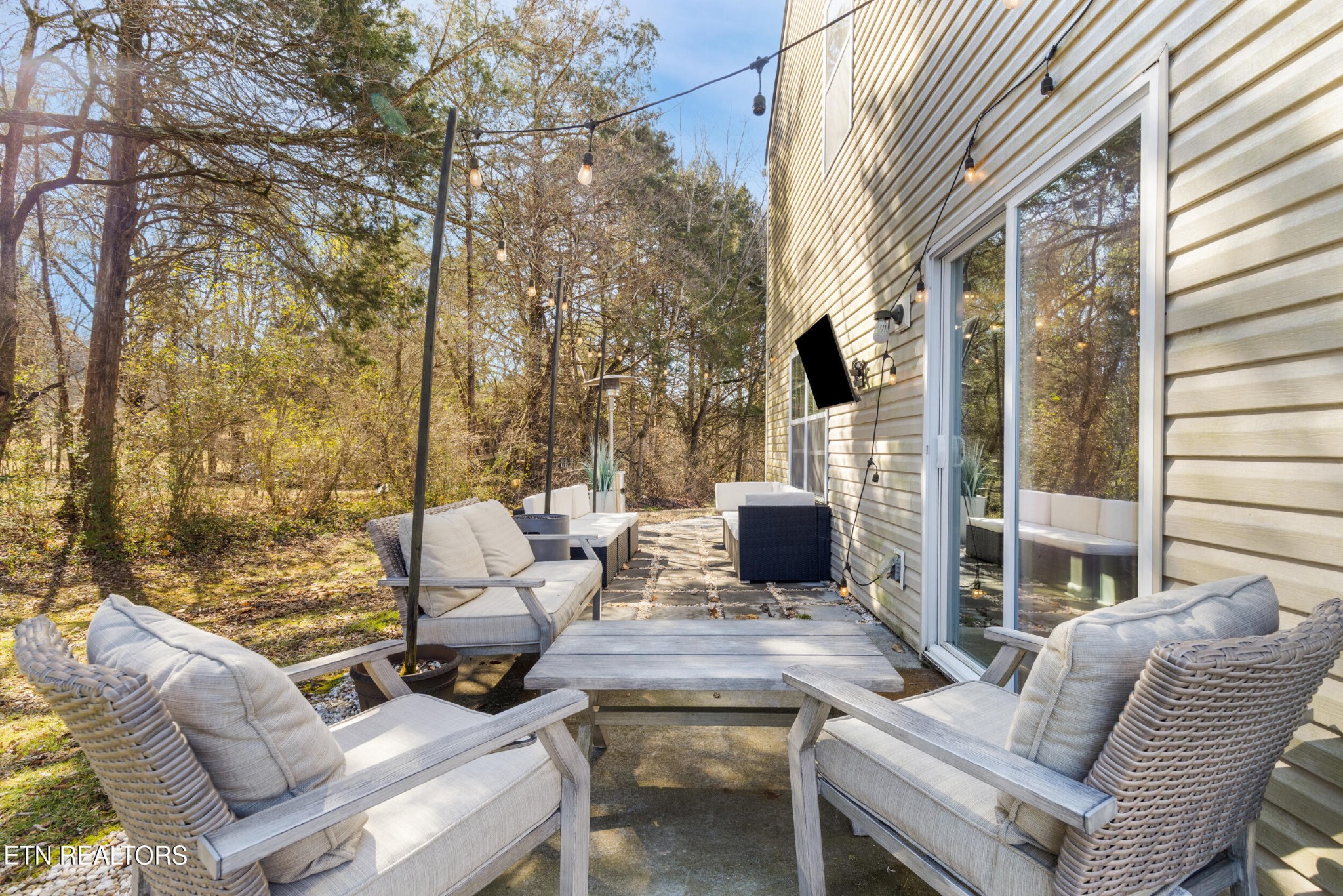 7200 Ponds Inlet Lane Powell, TN 37849 - Photo 27 of 38 a view of a patio with couches table and chairs and potted plants
