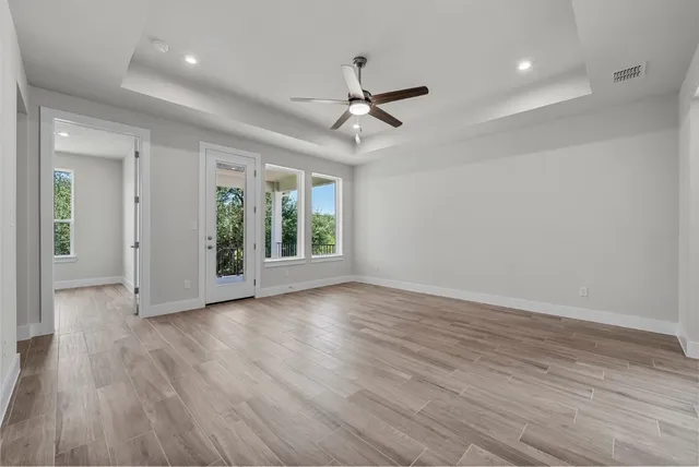 wooden floor in an empty room with a window
