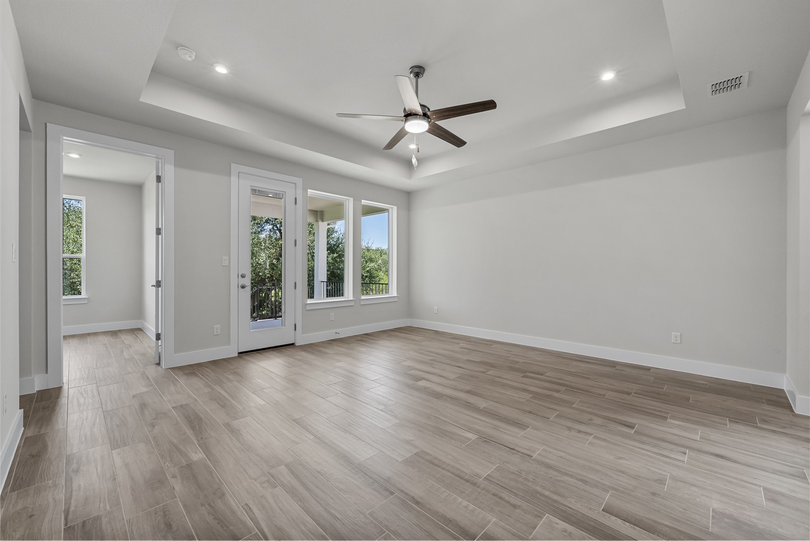 674 Iron Willow Loop Dripping Springs, TX 78620 - Photo 14 of 33 wooden floor in an empty room with a window
