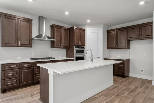 a kitchen with stainless steel appliances a sink stove and refrigerator