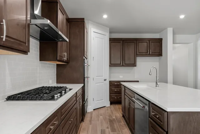 a kitchen with a sink a stove and cabinets