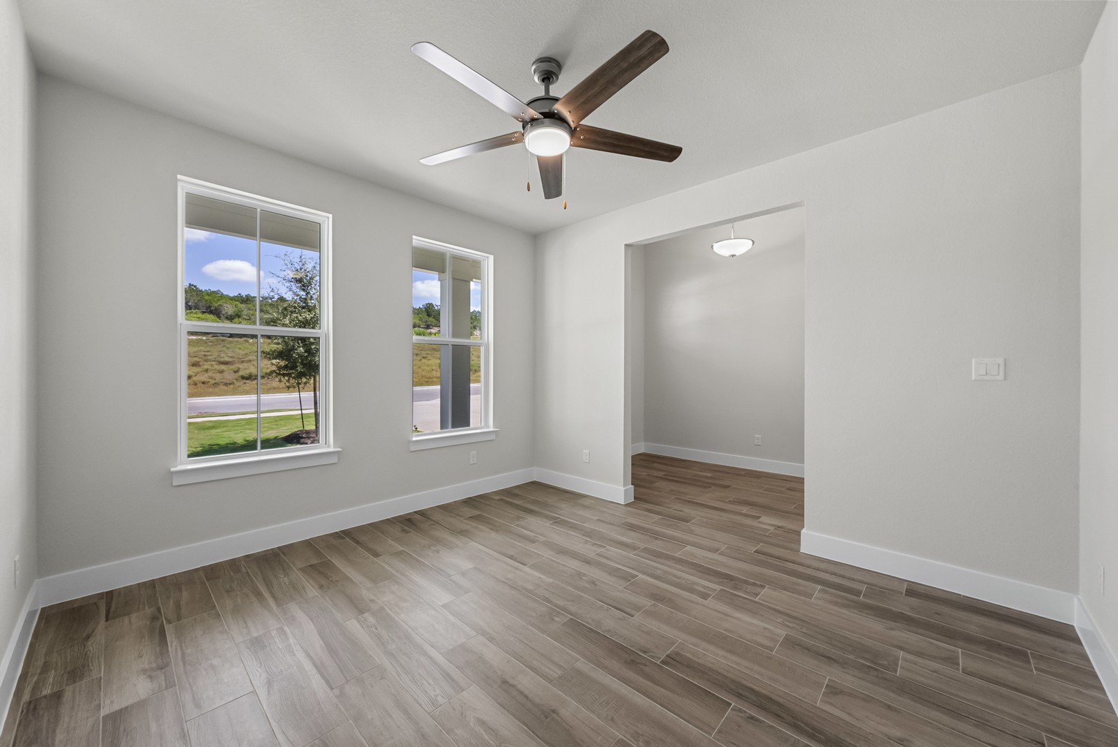 674 Iron Willow Loop Dripping Springs, TX 78620 - Photo 20 of 33 wooden floor in an empty room with a window