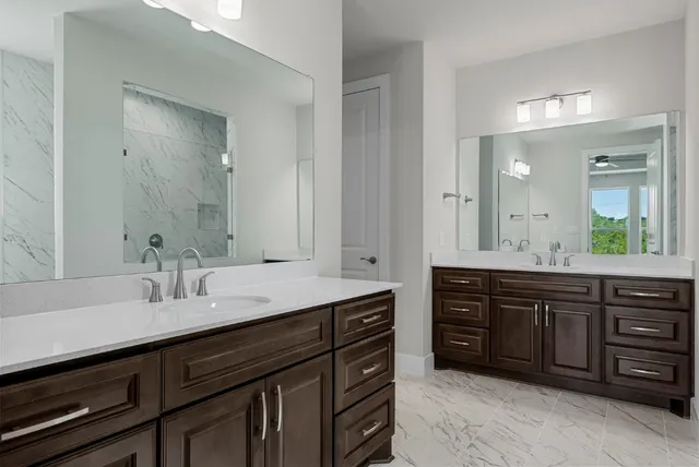 a bathroom with a sink double vanity and a mirror