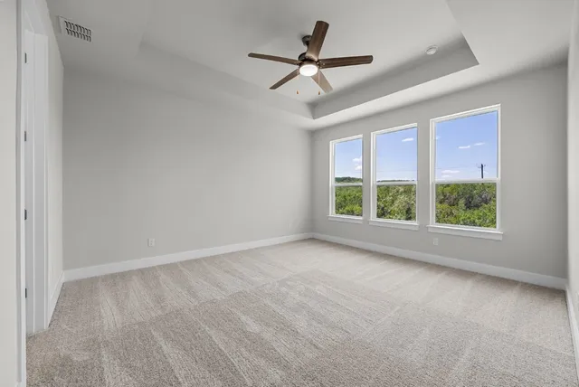 a view of room with ceiling fan and window