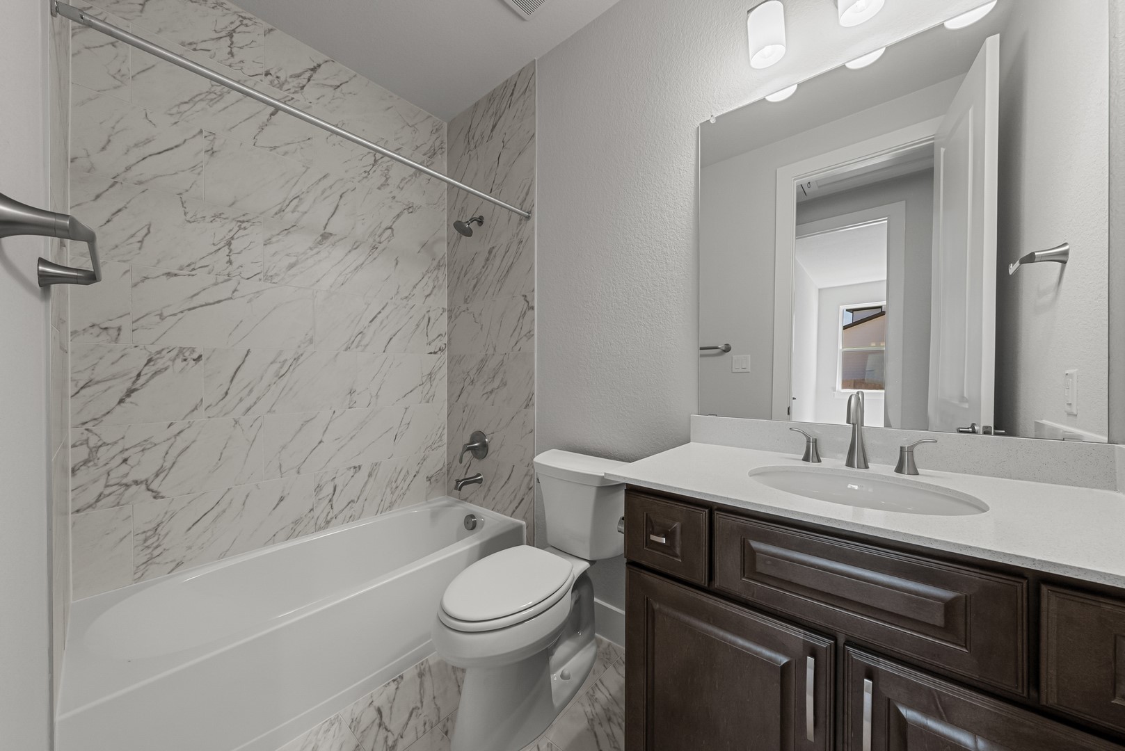 674 Iron Willow Loop Dripping Springs, TX 78620 - Photo 25 of 33 a bathroom with a sink a toilet and bathtub