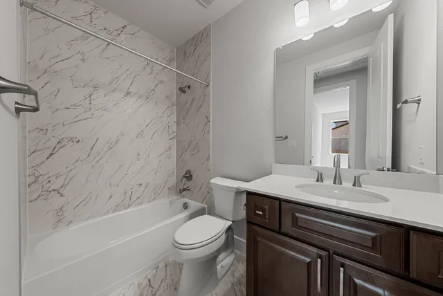 a bathroom with a sink a toilet and bathtub