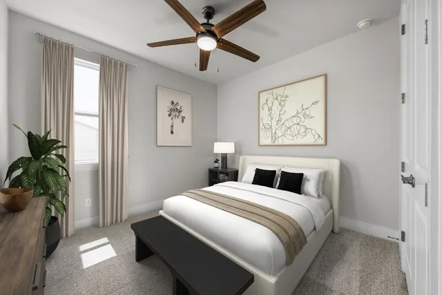 a bedroom with a large bed and a potted plant