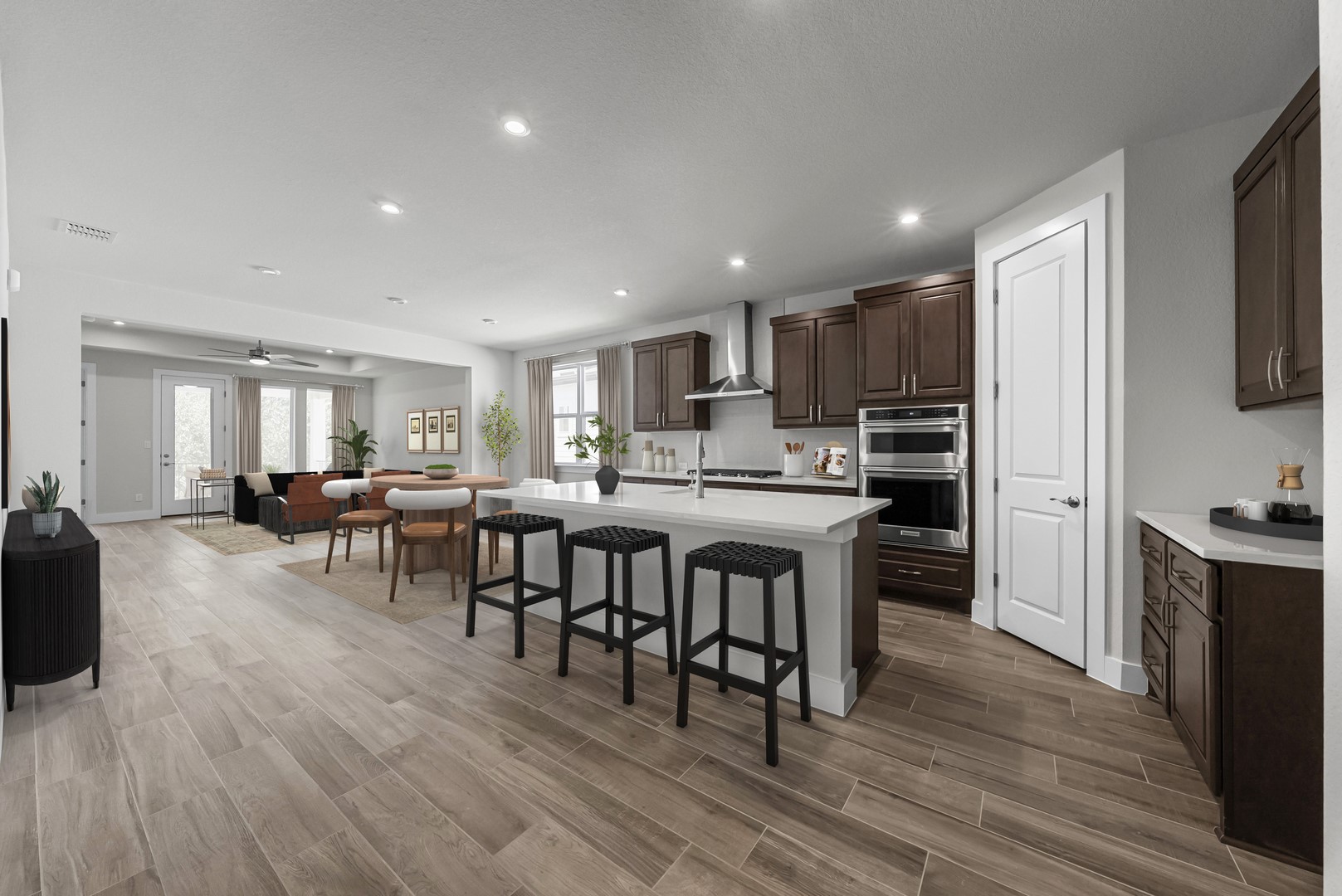 674 Iron Willow Loop Dripping Springs, TX 78620 - Photo 9 of 33 a living room with stainless steel appliances granite countertop furniture wooden floor and a kitchen view