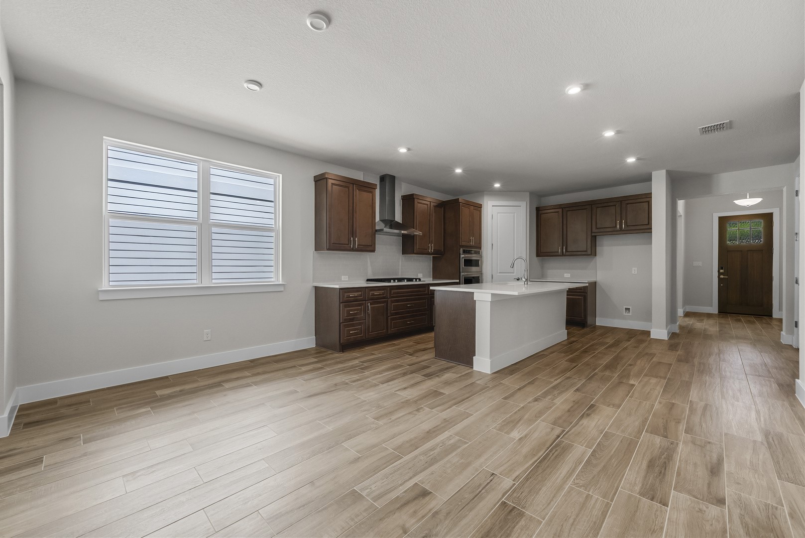674 Iron Willow Loop Dripping Springs, TX 78620 - Photo 10 of 33 a kitchen with stainless steel appliances kitchen island wooden cabinets a stove a sink and a refrigerator