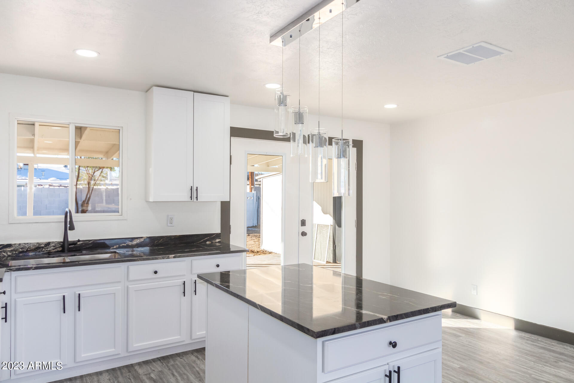 2913 West Charter Oak Road Phoenix, AZ 85029 - Photo 8 of 23 a kitchen with granite countertop a sink and a refrigerator