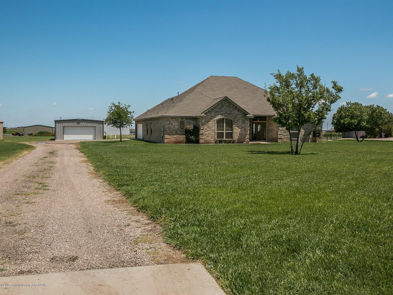 9151 Greyhawk Road Amarillo, TX 79119 - Photo 30 of 31 a front view of a house with garden
